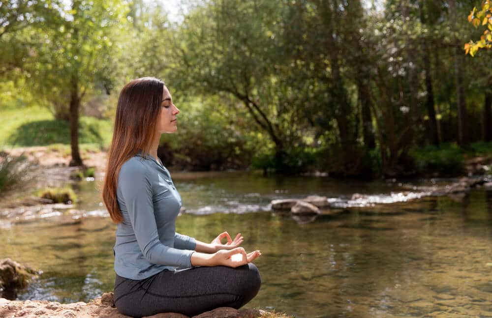 Woman Meditating to get rid of a negative mindset