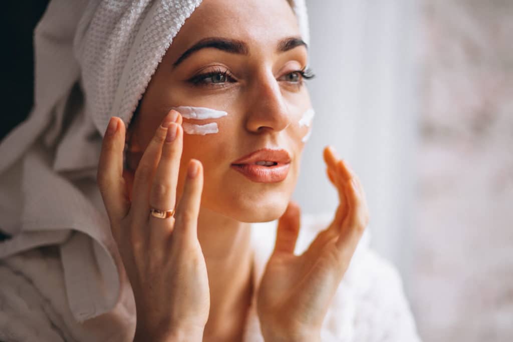 woman-applying-face-cream